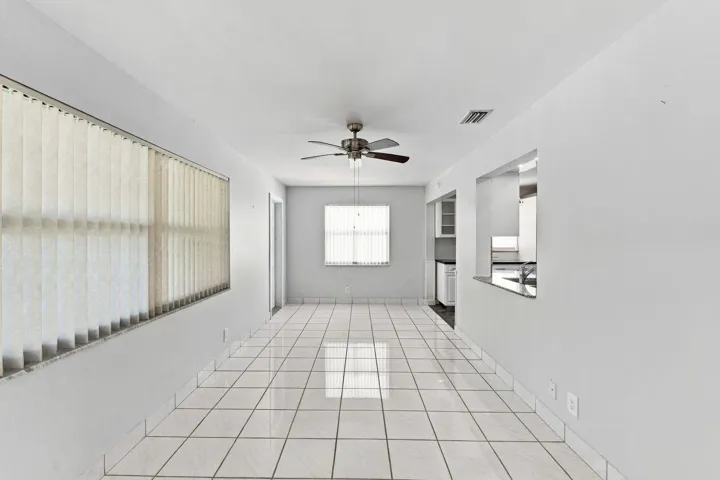 Large, open area with pass through to kitchen and entrance to outside patio