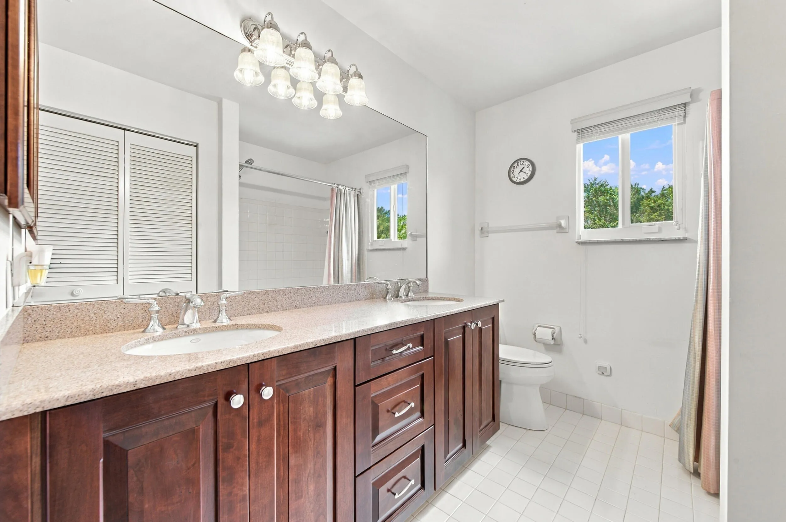Double vanity with a light-toned countertop, dual undermount sinks, and chrome faucets