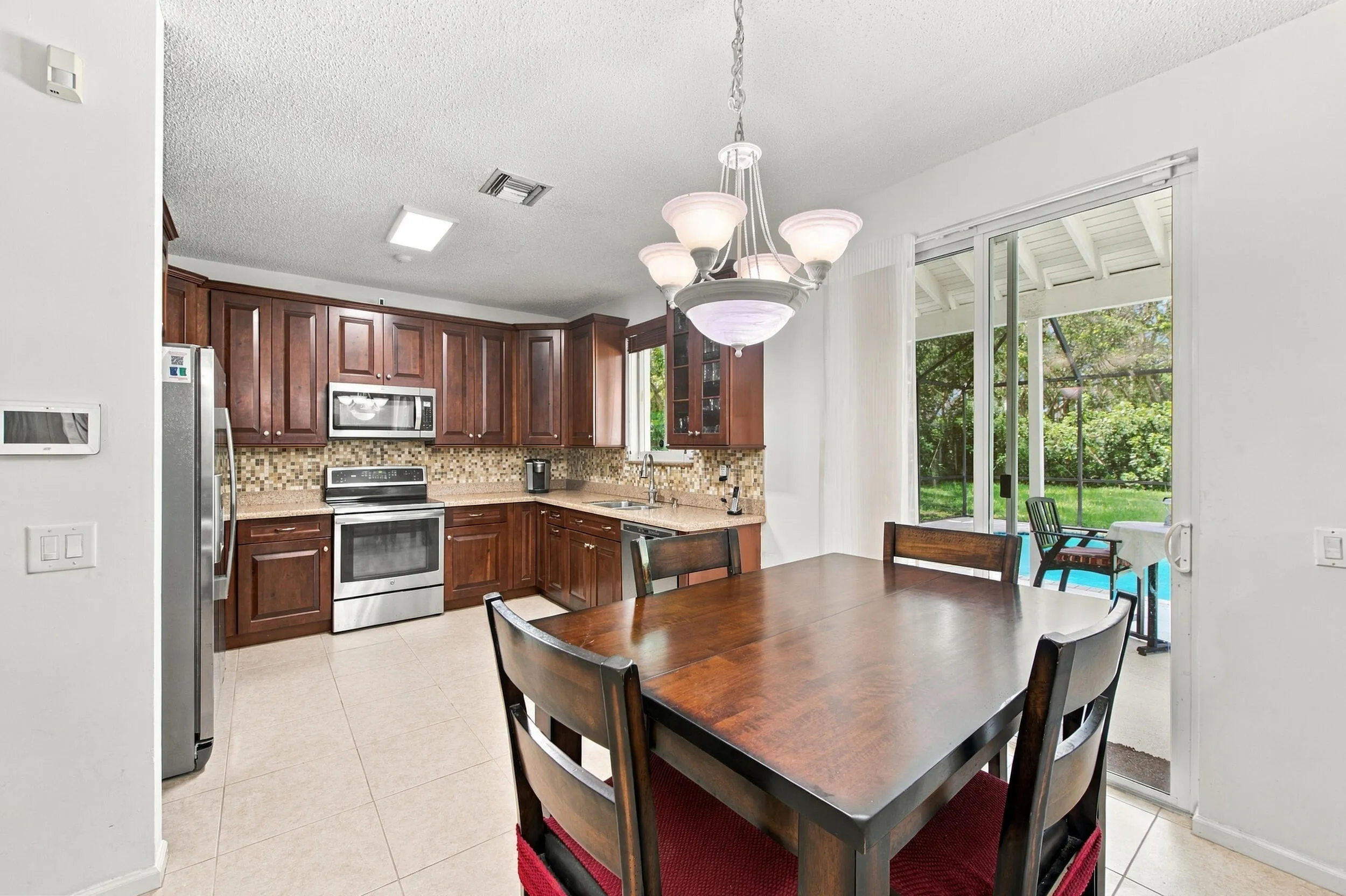 Kitchen featuring wood cabinetry, stainless steel appliances, and a mosaic tile backsplash