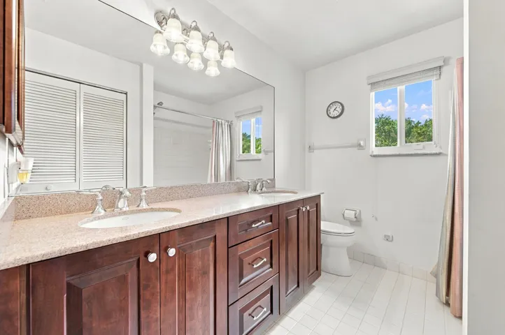 Double vanity with a light-toned countertop, dual undermount sinks, and chrome faucets