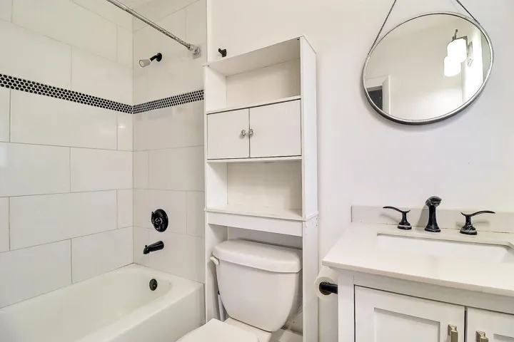 White subway tile surround with black accent mosaic