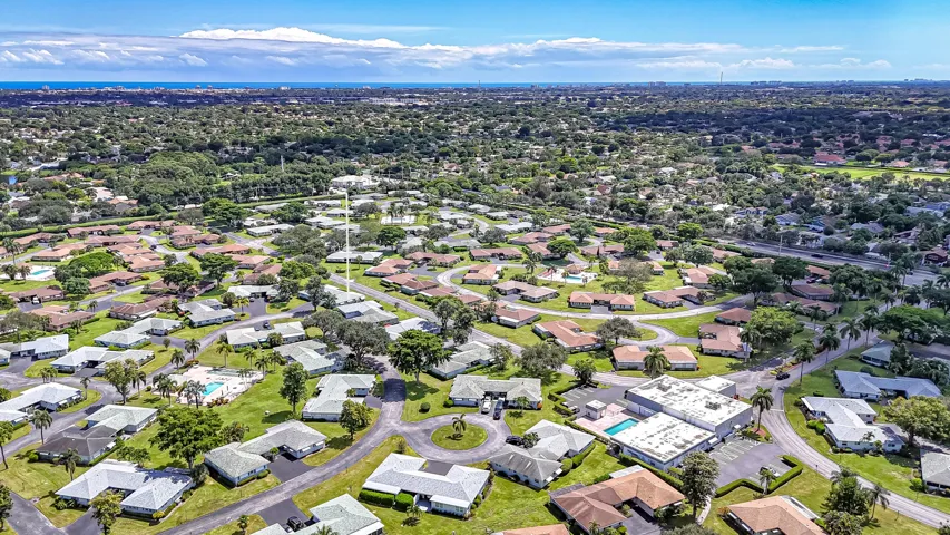 Expansive residential area with numerous single-story homes, mature trees, and paved roads