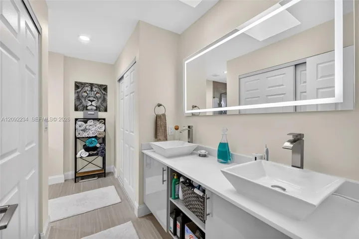 Top of the Line Dual Sinks and Lighted Mirror in the Master Bathroom