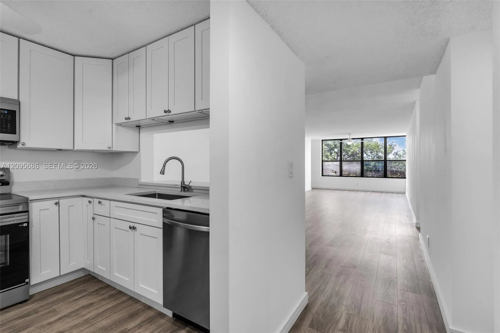 Functional kitchen entryway showcasing full cabinet depth and easy-care flooring.
