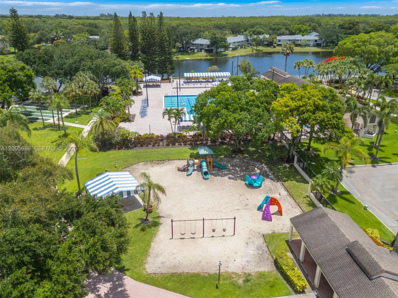 Aerial view highlighting the community’s lush grounds, recreational amenities, and waterfront setting.