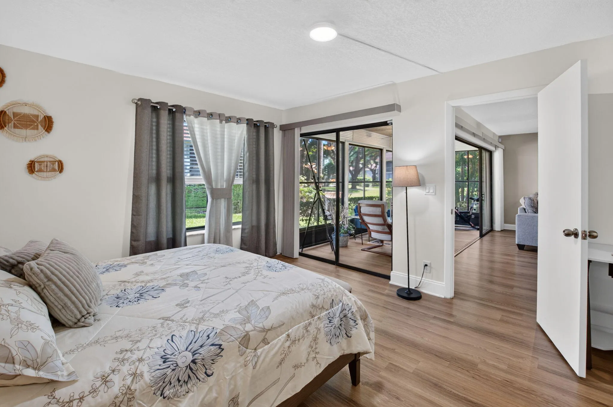 Wood-finish flooring throughout, sliding glass doors to a screened outdoor area