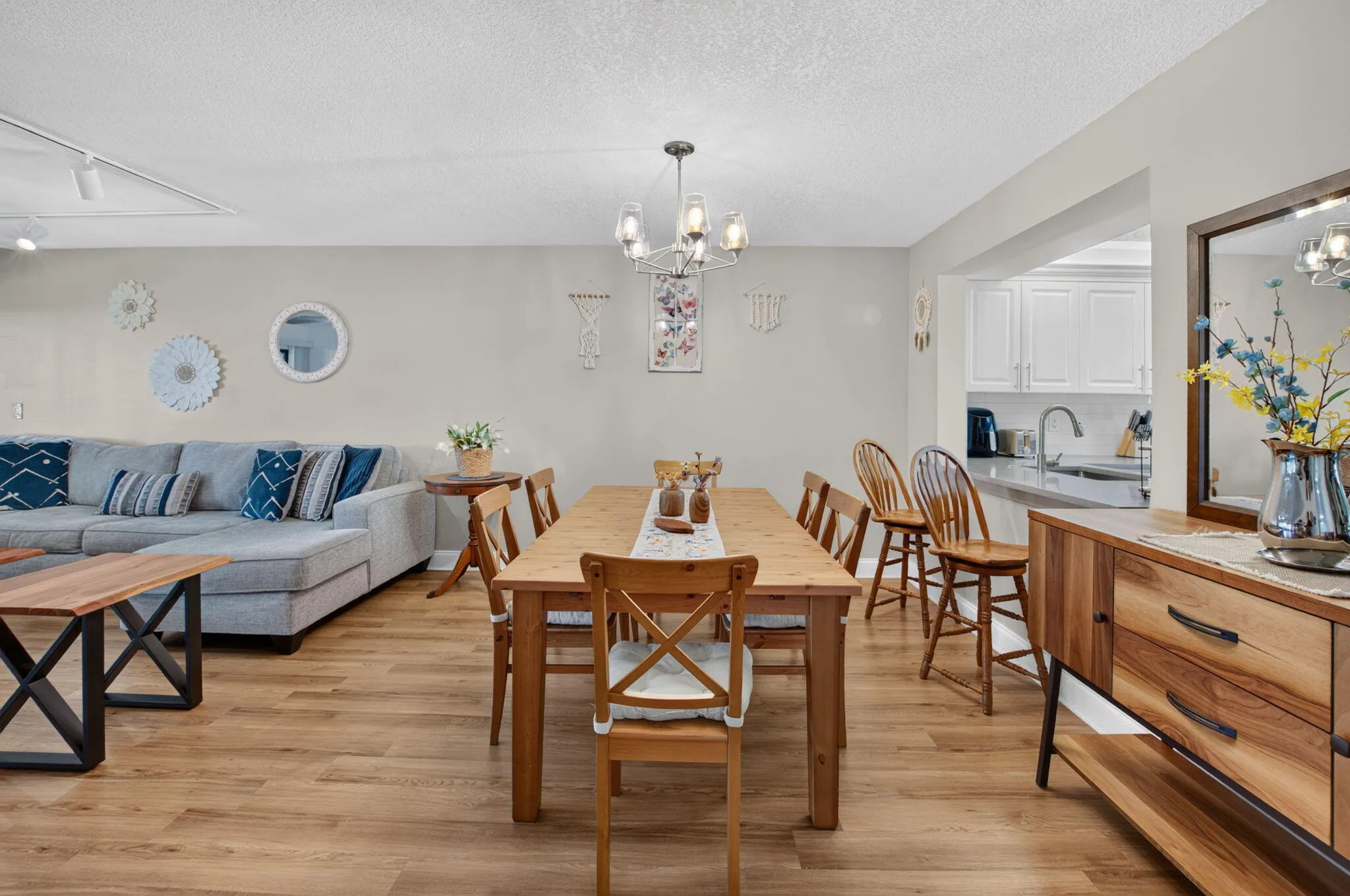 Wood-finish flooring throughout, complemented by a modern chandelier