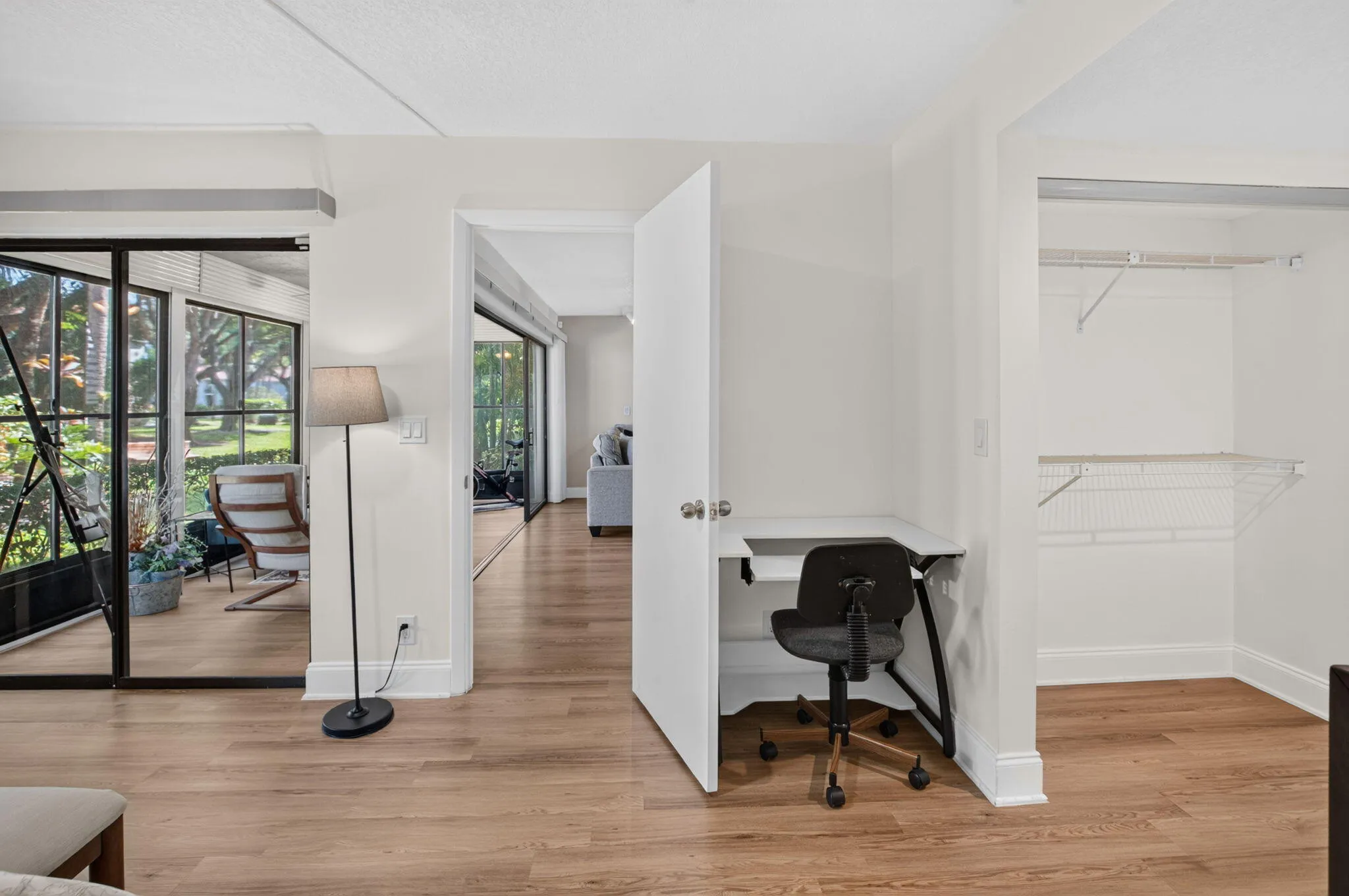 Wood-finish flooring throughout, with a desk area and wall closet