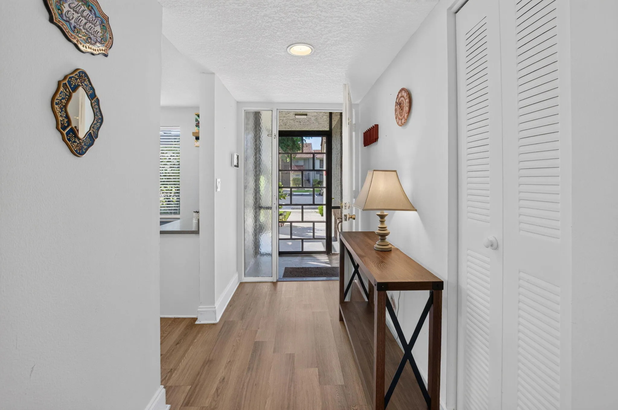 Entryway featuring wood-finish flooring, and recessed lighting
