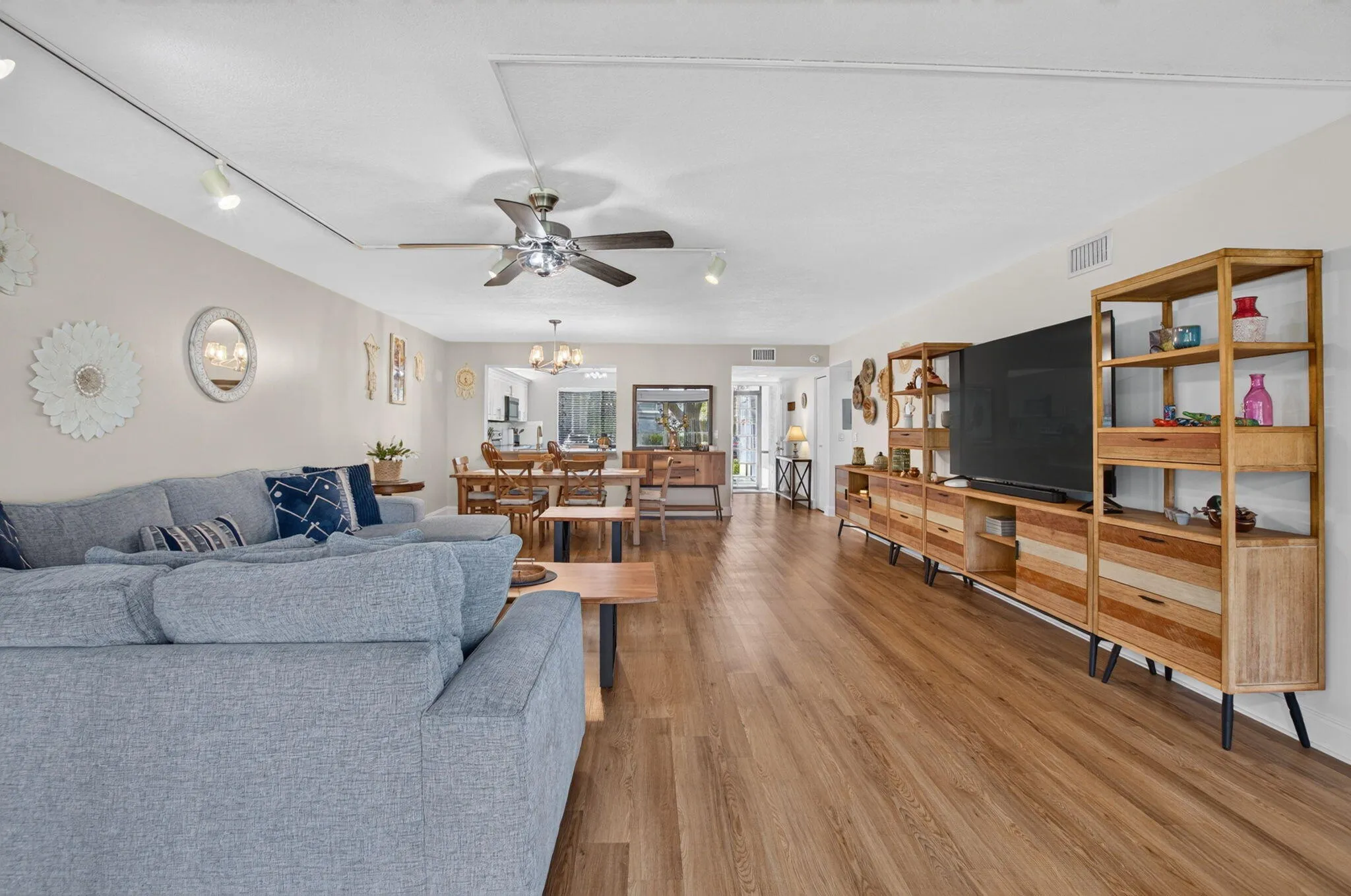 Wood-finish flooring extends throughout the open living area