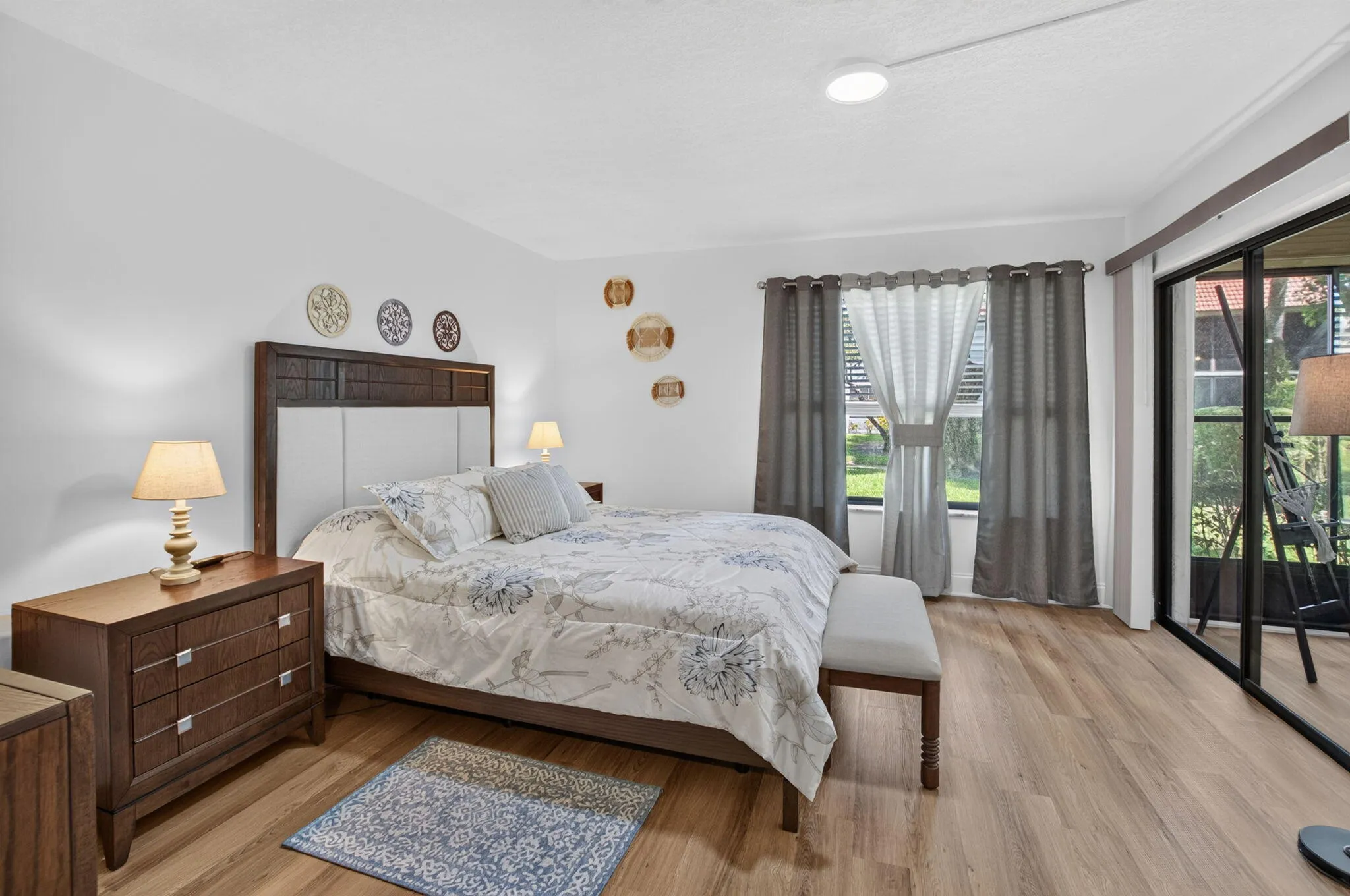 Wood-finish flooring, white walls, and sliding glass doors to the Florida room