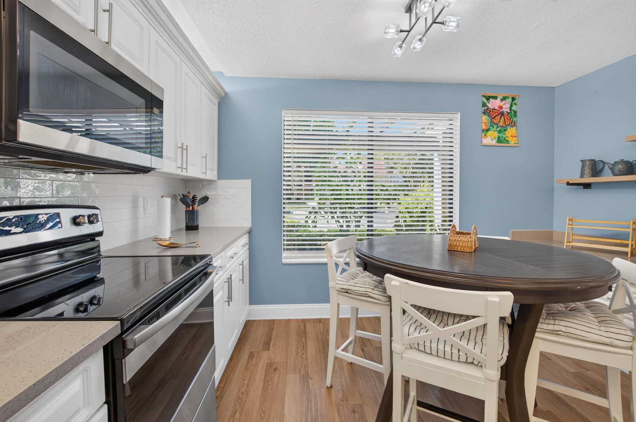 Modern kitchen with white cabinetry and stainless steel appliances
