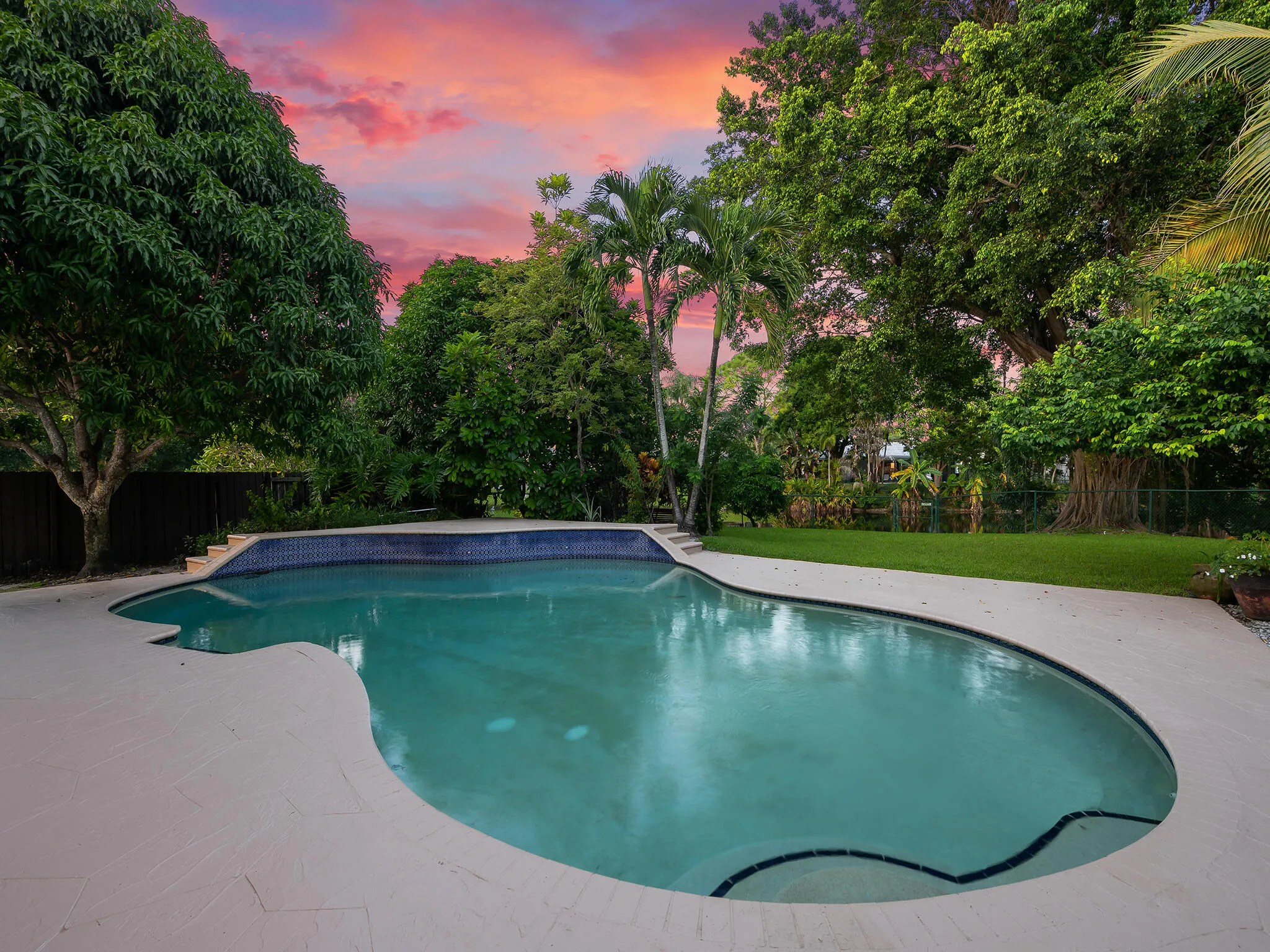 Sunset paints the sky over your private pool.