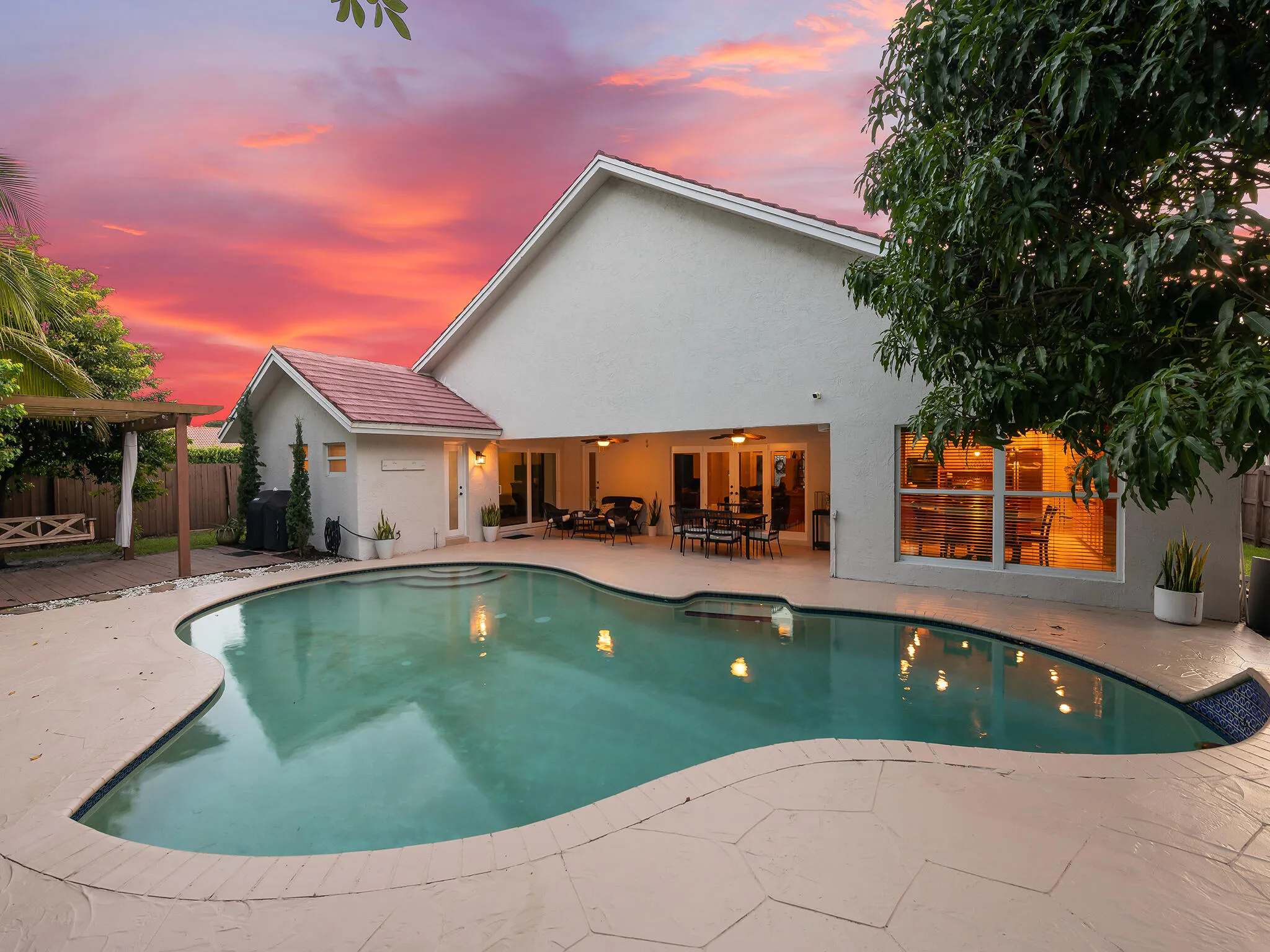 Resort style rear elevation glows at dusk.