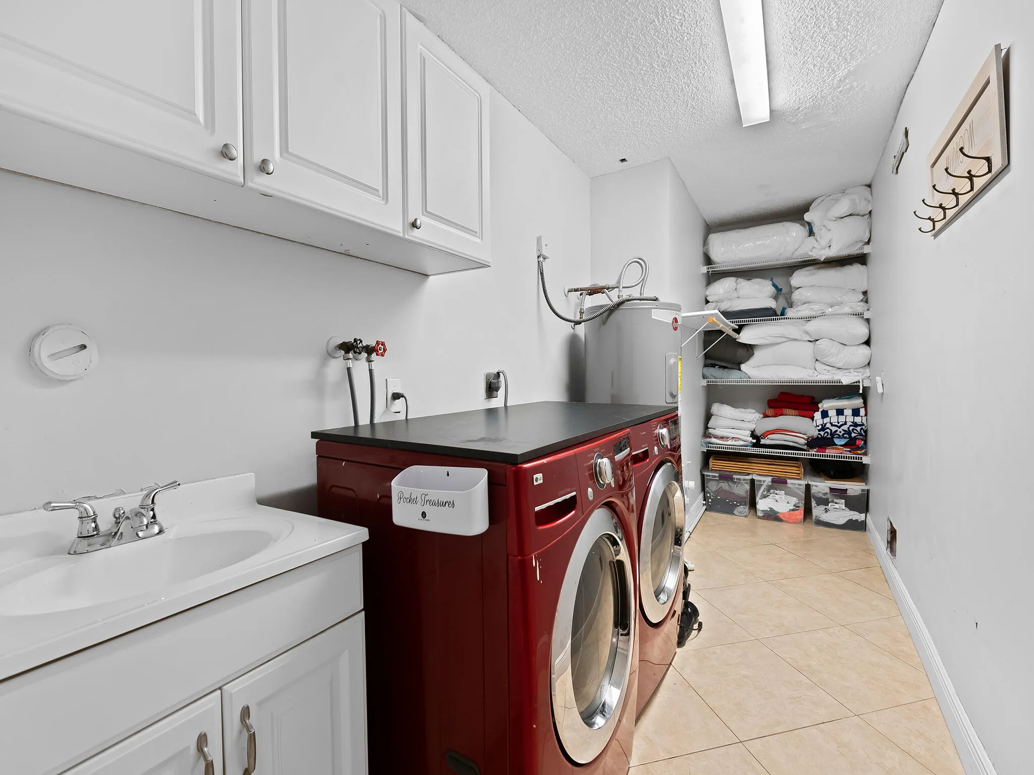 Laundry room with full size washer dryer and storage.