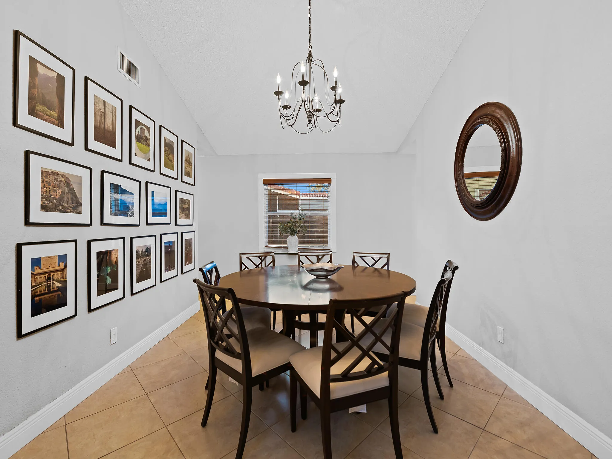 Formal dining with gallery wall and chandelier.