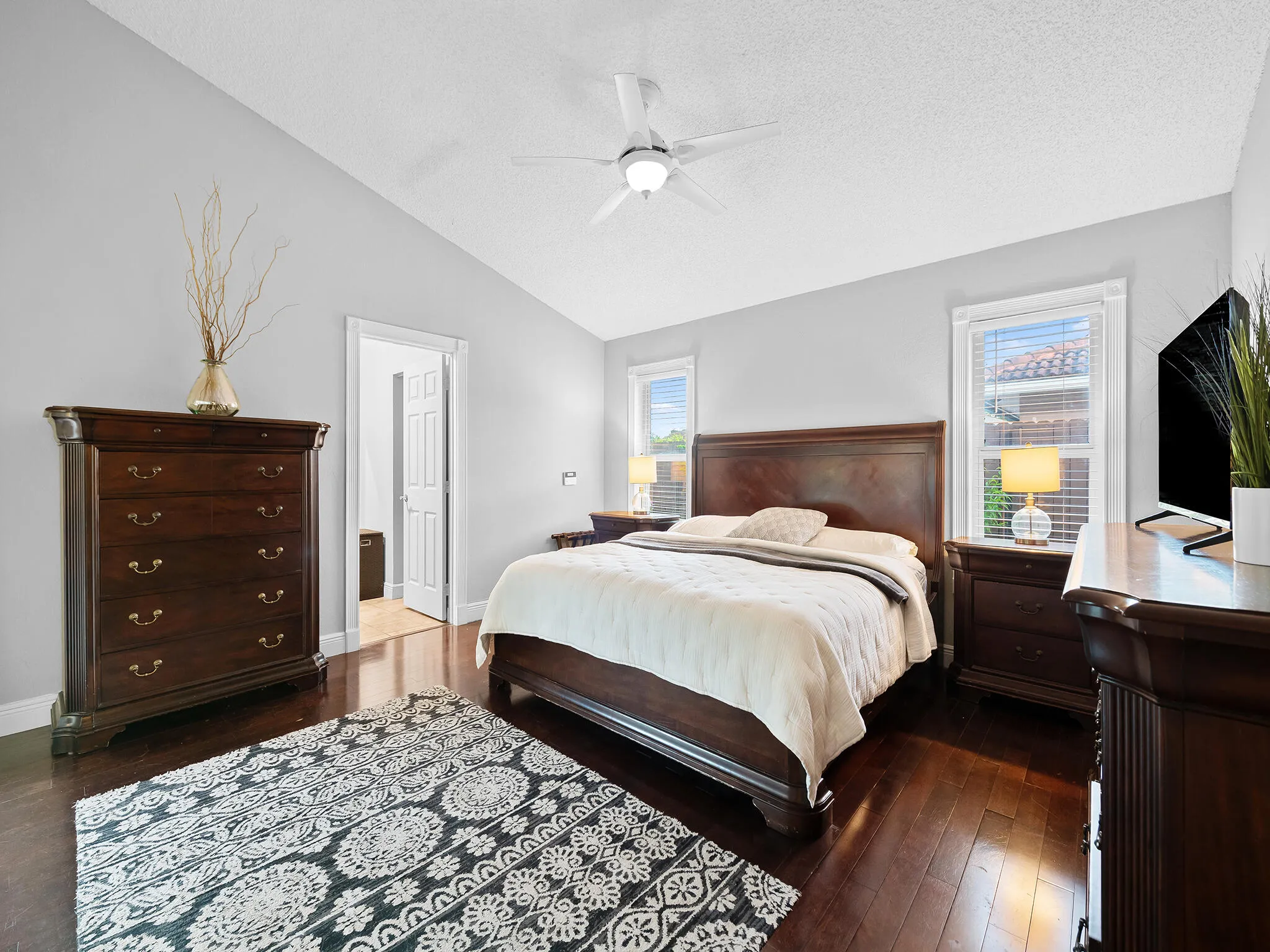 Retreat like primary suite in rich hardwoods.