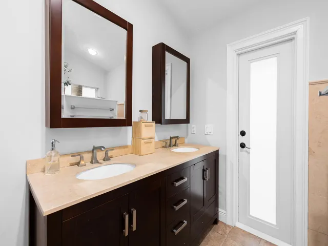 Warm wood vanity with boutique hotel style.