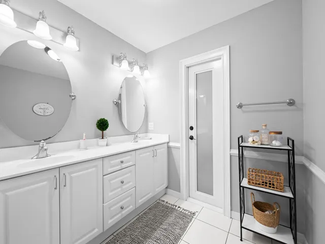 Primary bath with double vanity and natural light.
