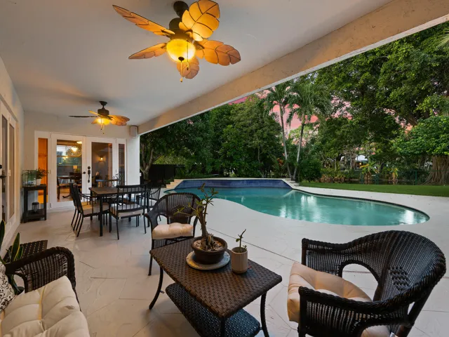 Shaded lounge seating with fans over the pool.