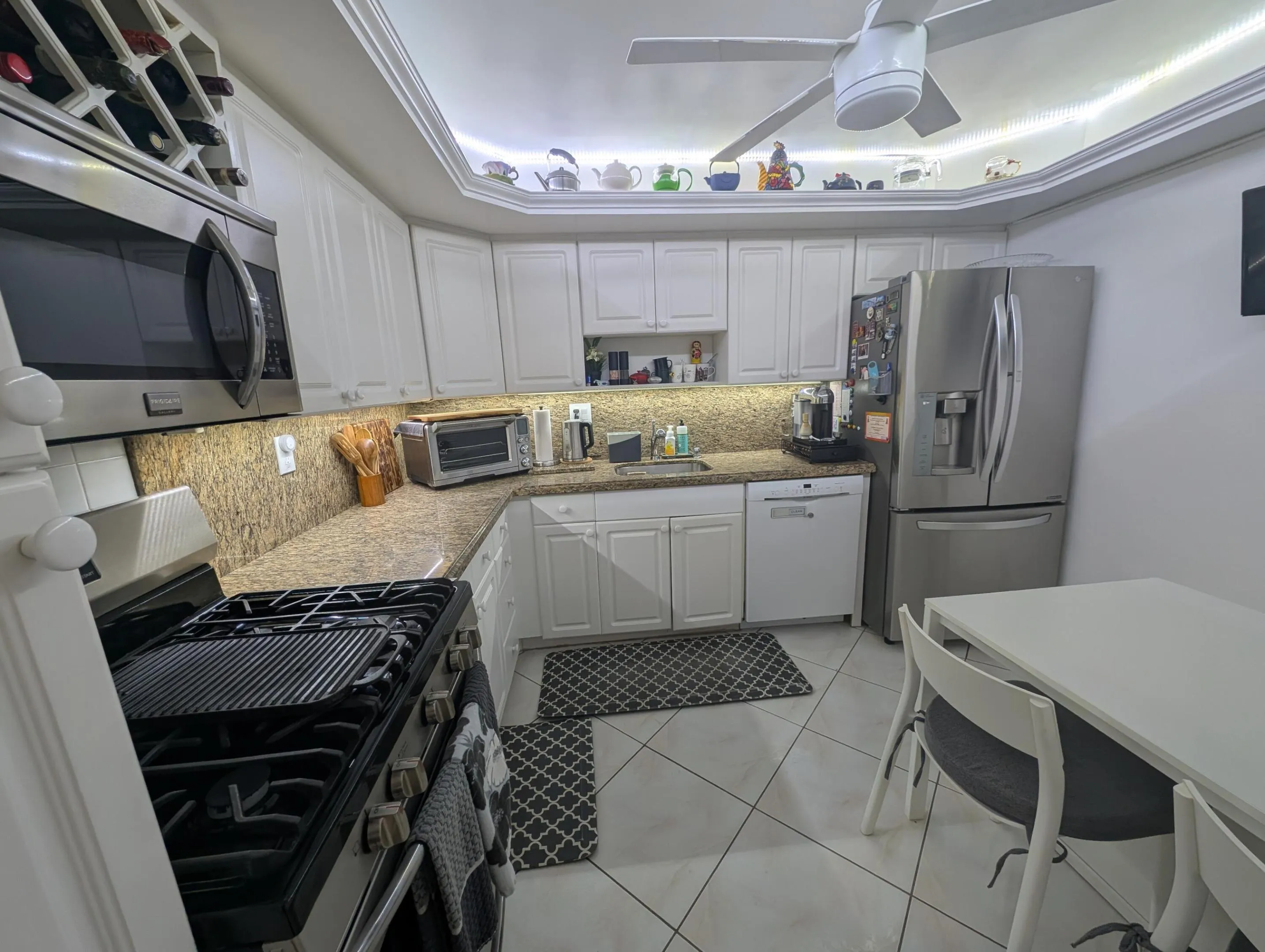 Kitchen Featuring Granite Top & Stainless Steel Appliances