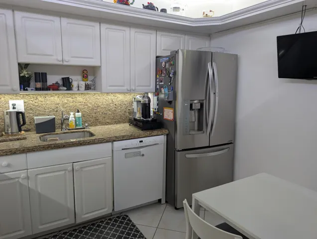 Kitchen Featuring Granite Top & Stainless Steel Appliances