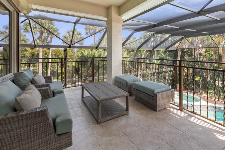 Just beyond the game room, the private balcony offers a breezy perch above the pool—perfect for slipping outside with a morning coffee or evening cocktail.