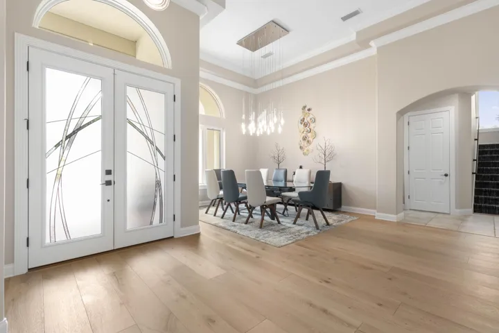 Custom glass entry doors introduce a light-filled interior, soaring proportions and statement lighting give the first moments inside a distinctly sophisticated feel.