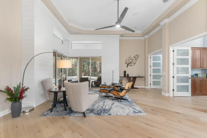 Step into a space where sunlight dances across wide-plank floors and modern elegance meets easy comfort—this inviting living area feels like the start of your next chapter.