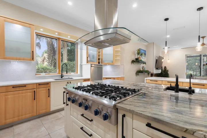 Where serious cooking gets its moment—the professional-style gas range, statement hood and expansive stone work surface give the home chef a kitchen worthy of their best recipes.
