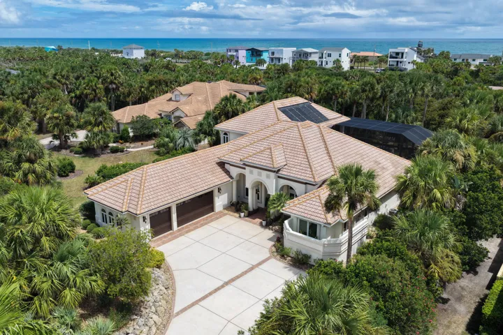 From the moment you arrive, 113 Island Estates Pkwy feels distinctly private and refined—an elegant estate tucked into its coastal surroundings with the blue Atlantic waiting just beyond.