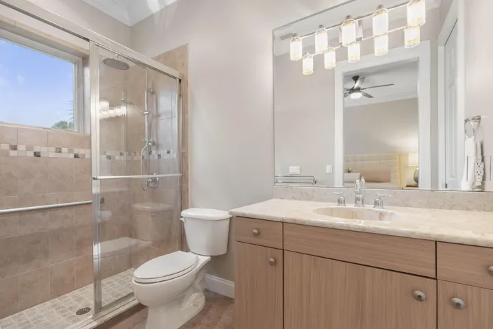 A bright ensuite bath gives Guest Suite #1 its own private space, complete with a walk-in shower and plenty of vanity storage.