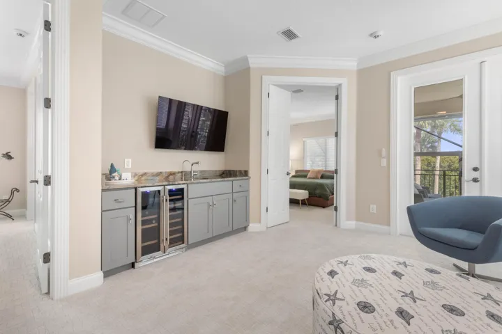 A stylish wet bar keeps drinks and refreshments within easy reach, adding a fun finishing touch to this second-floor hangout.