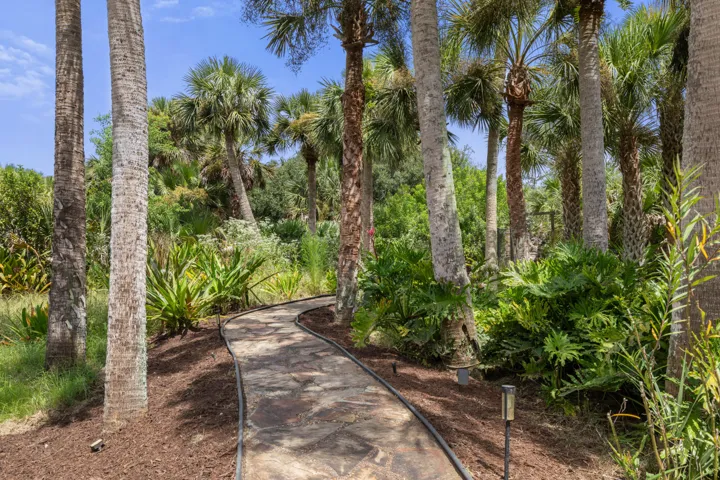 Follow the winding path through lush tropical landscaping, and the story leads to the water—your private boat dock and canal just ahead.