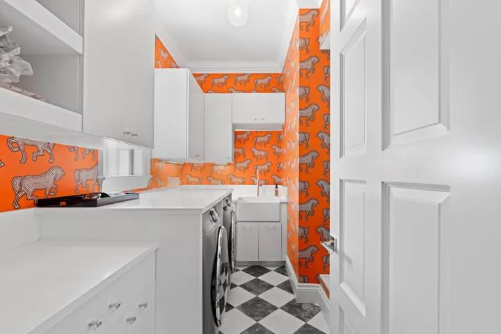 Schumacher wall paper adds a touch of glamour to this utility room