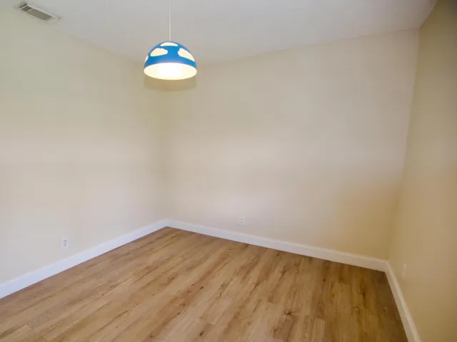 Wood-finish flooring with light-toned walls and white trim