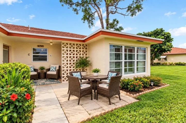 AI patio furniture added to front of the corner villa