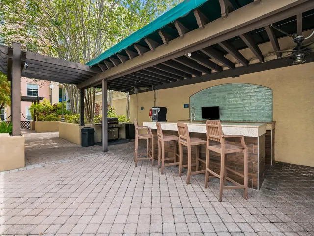 Poolside outdoor kitchen with grill and entertaining area