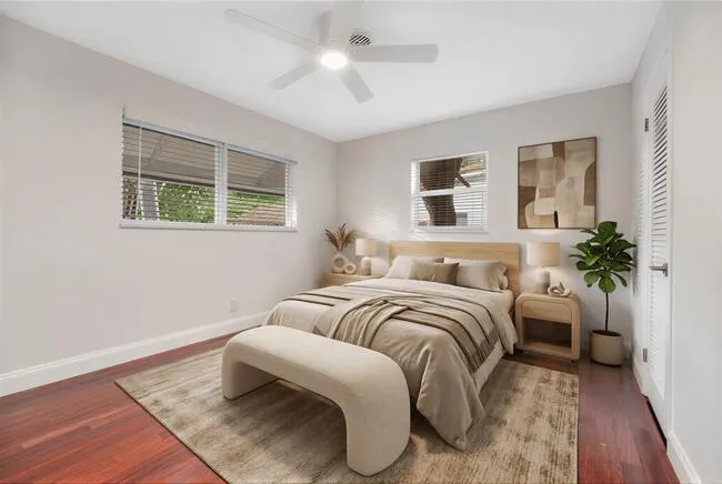 Virtually staged. Wood-finish flooring, white walls, and a ceiling fan with integrated lighting