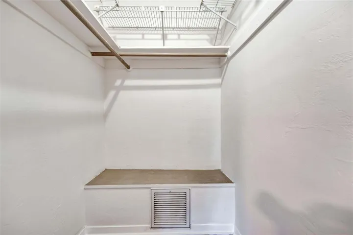 Built-in shelving, hanging rod, and additional storage platform