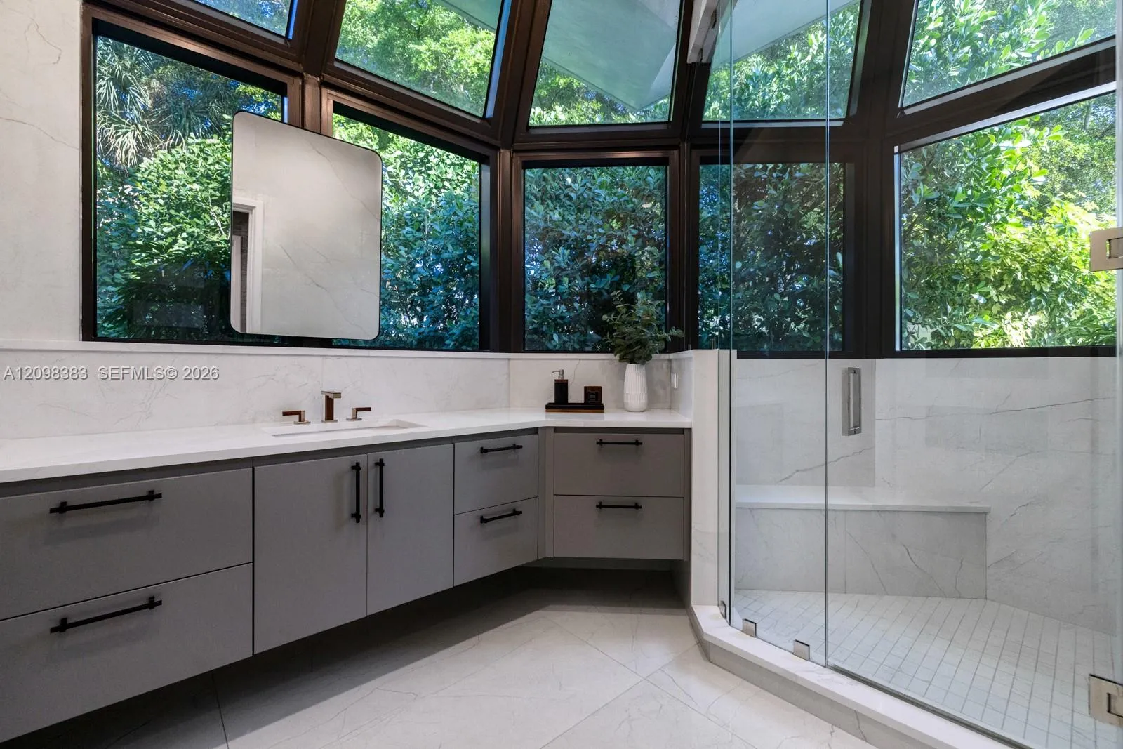 Spa-inspired primary bathroom with Steamist shower system at 2965 Surrey Lane, Weston Florida.