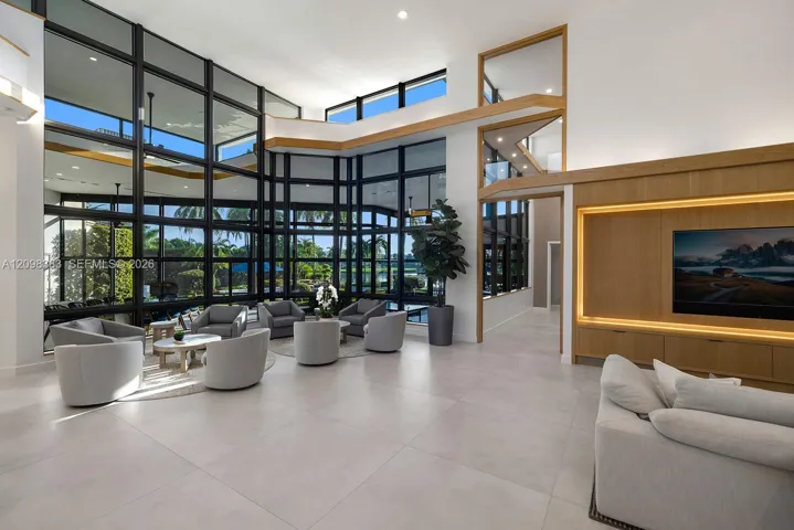 Double-height living room with expansive glass, soaring ceilings and organic modern architecture at 2965 Surrey Lane, Weston FL