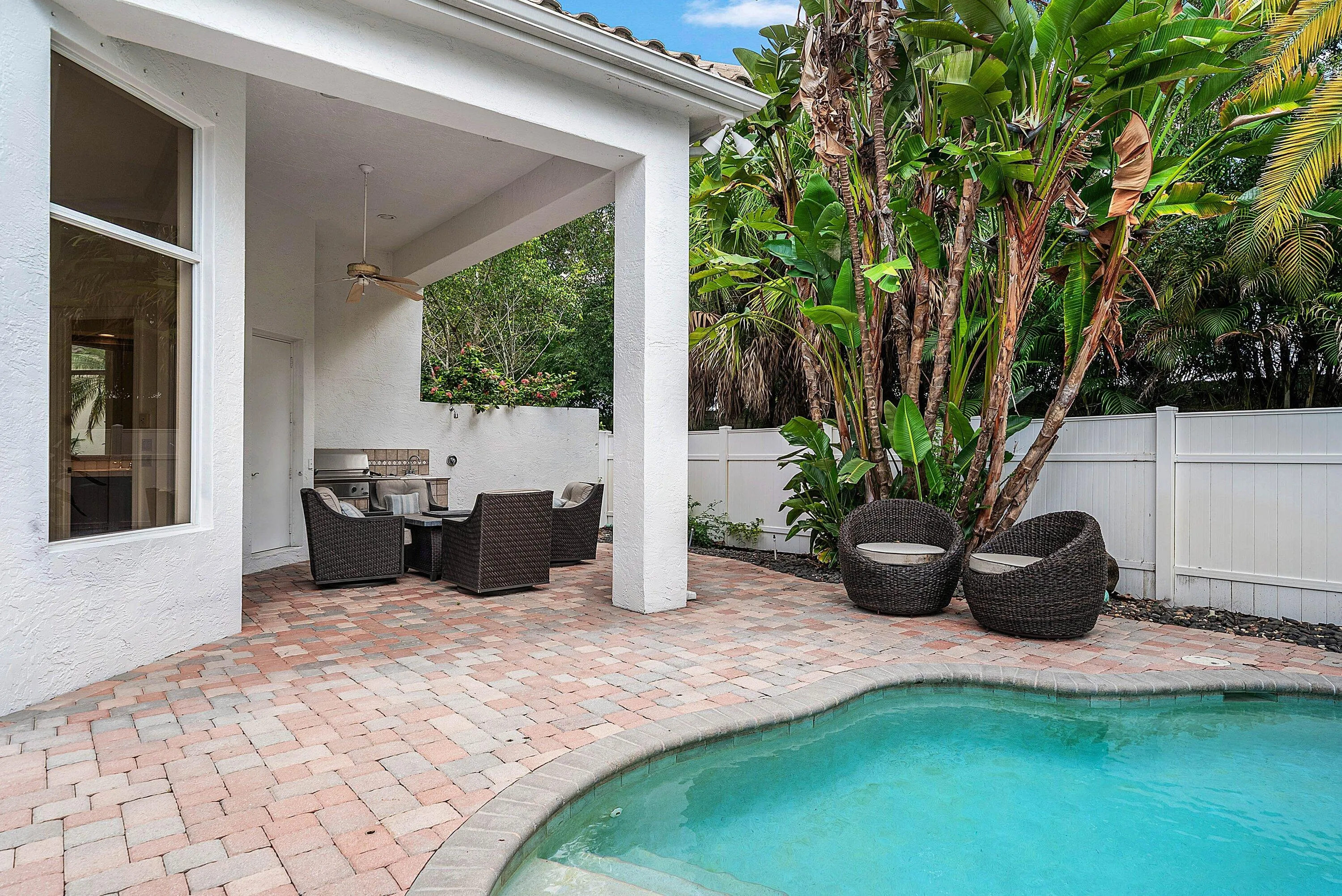 Brick paver patio with a built-in grill, covered lanai