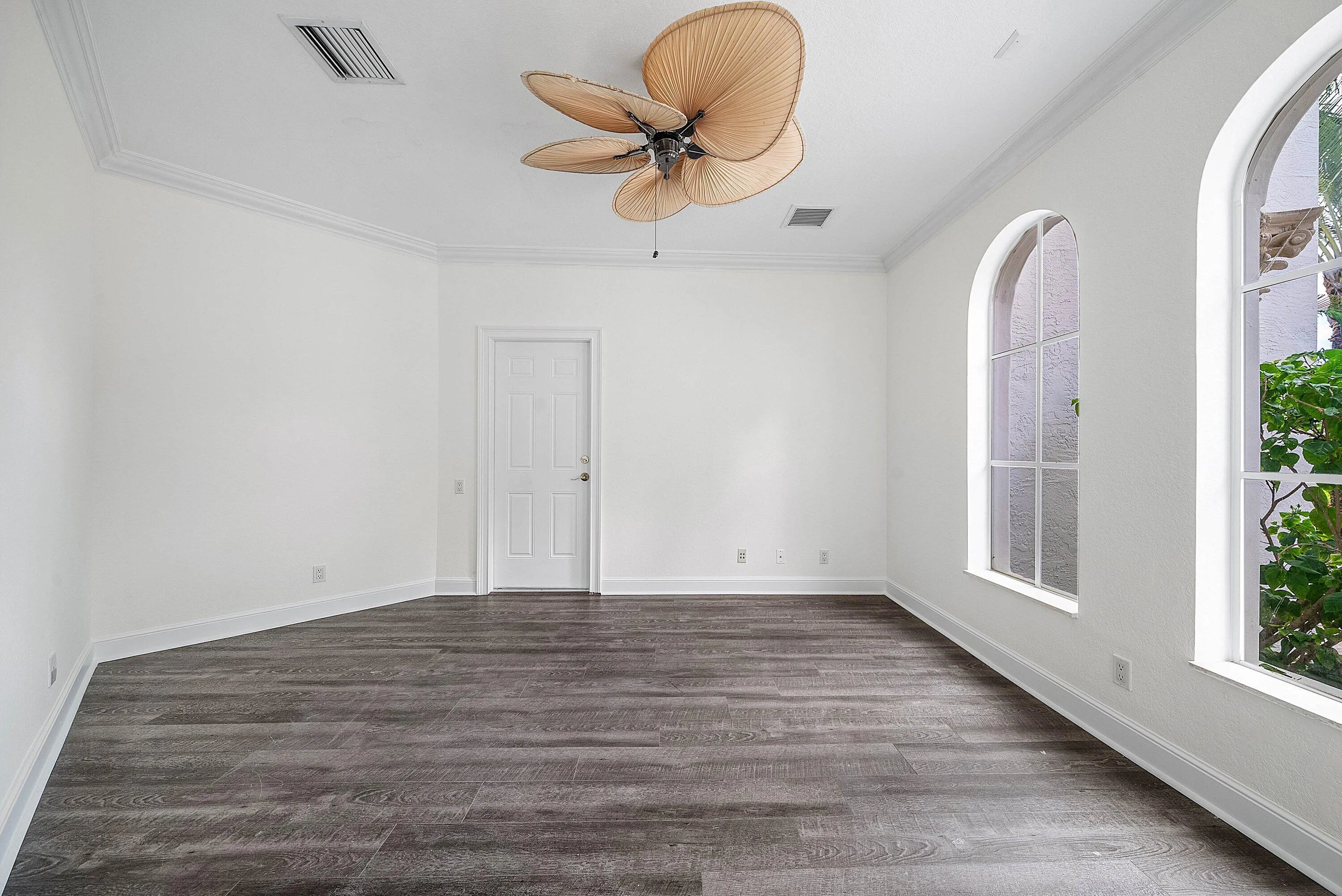 1st Floor Office/Den with wood-finish flooring, ample natural light and access to additional 1 car garage