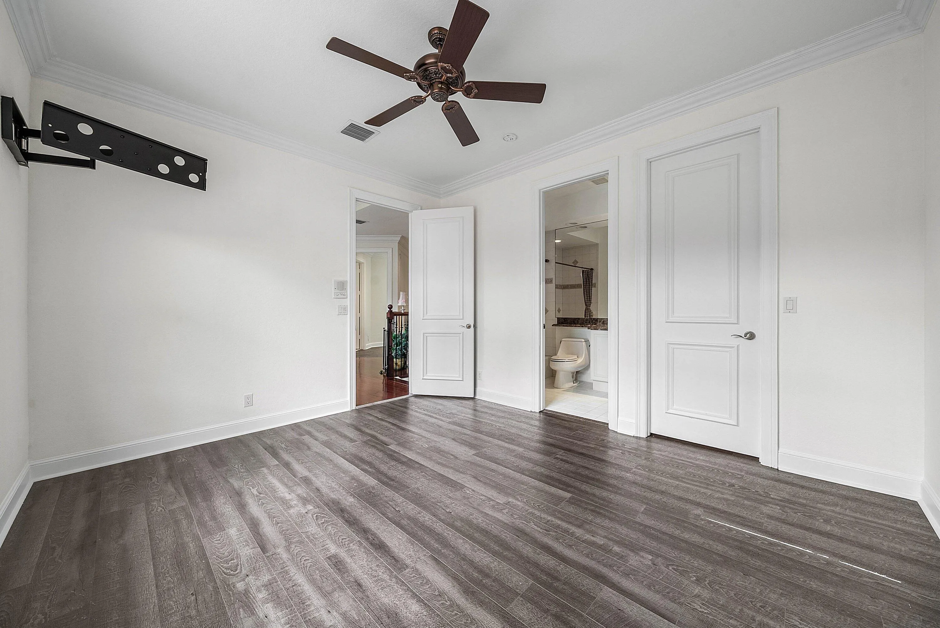 En-Suite bedroom #3 with wood-finish flooring throughout, crown molding, and a ceiling fan