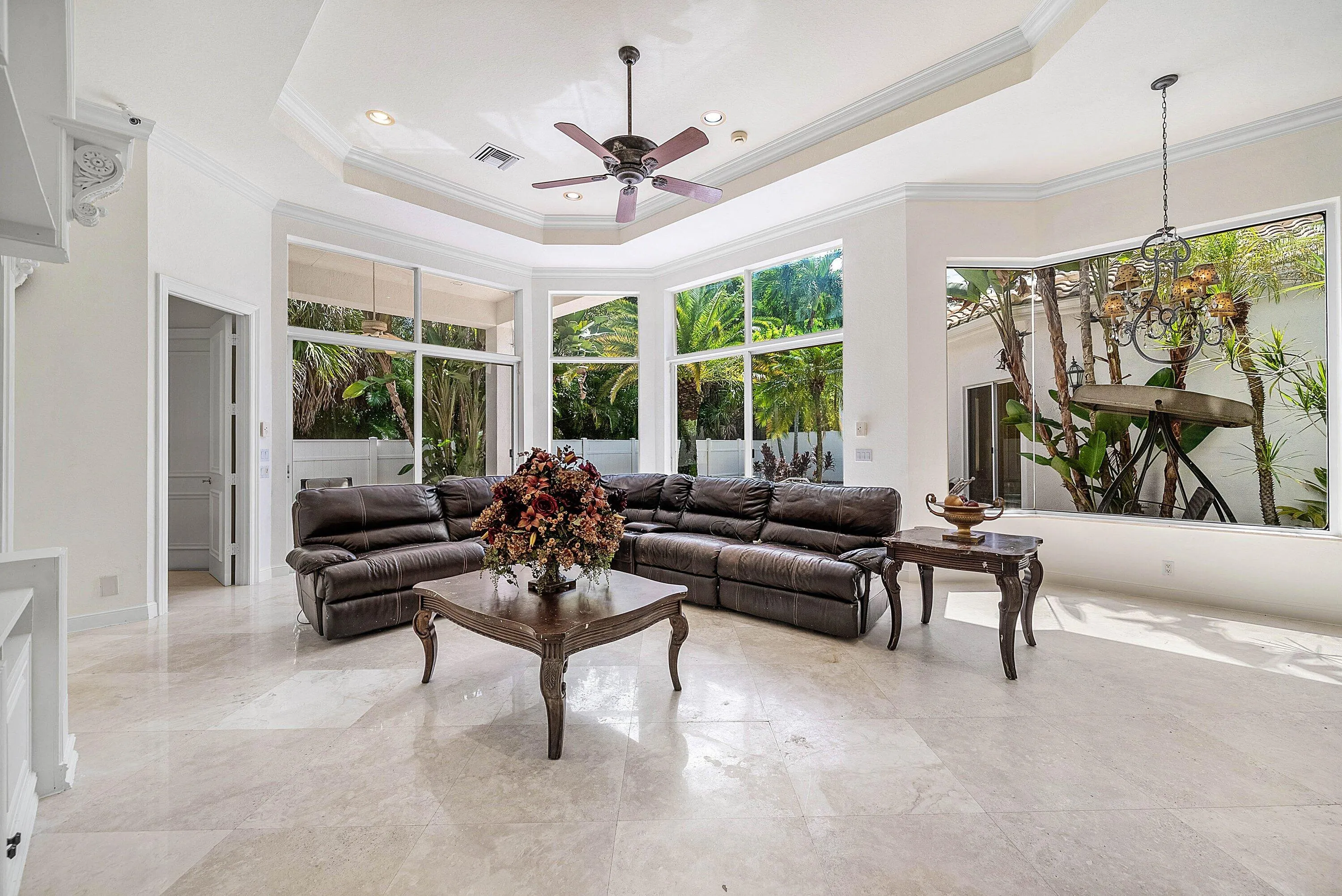 Expansive living space - walls of windows for natural light, marble flooring