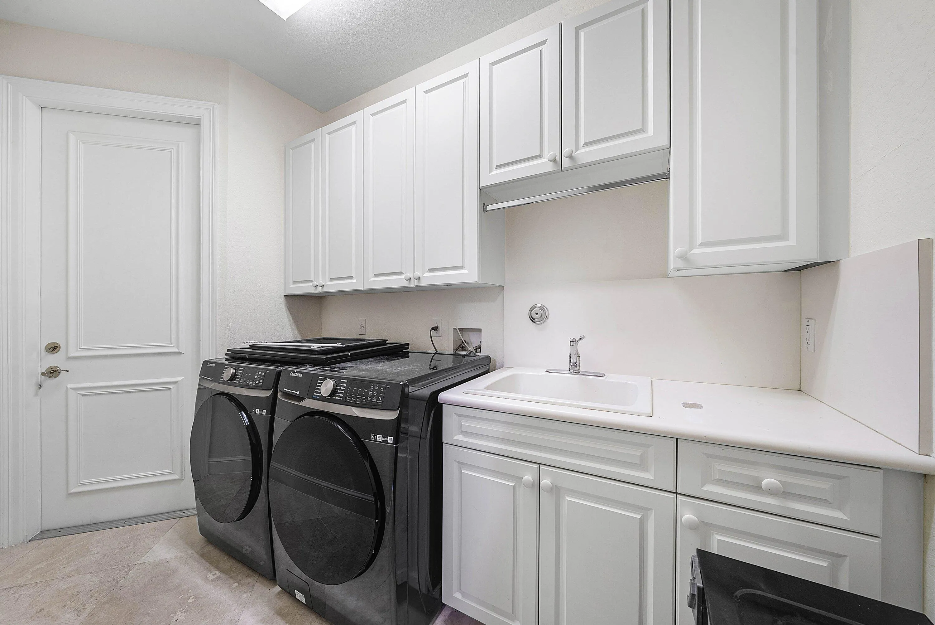 Laundry Room with ample storage, access to 2 car main garage