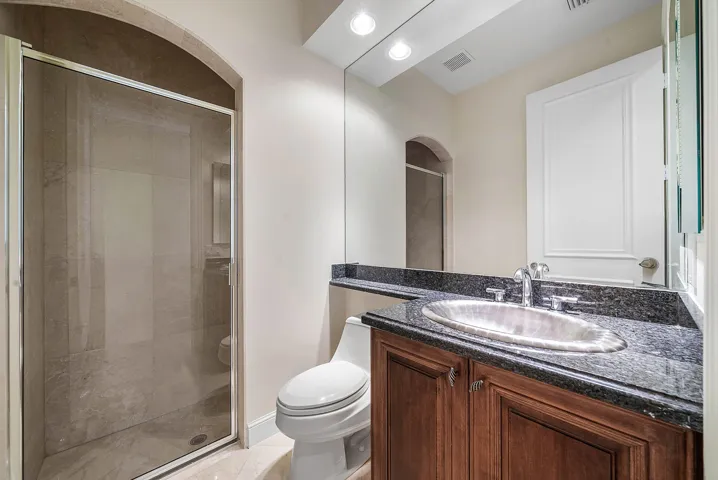 1st floor full bathroom with shower off of hallway leading to 2nd ground floor bedroom (currently media room)