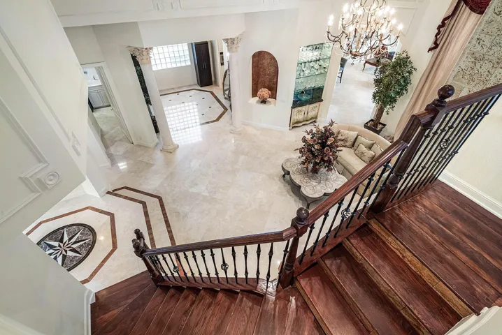 Hardwood stairs with wrought iron style balusters up to 2nd floor loft area and 3 additional bedrooms