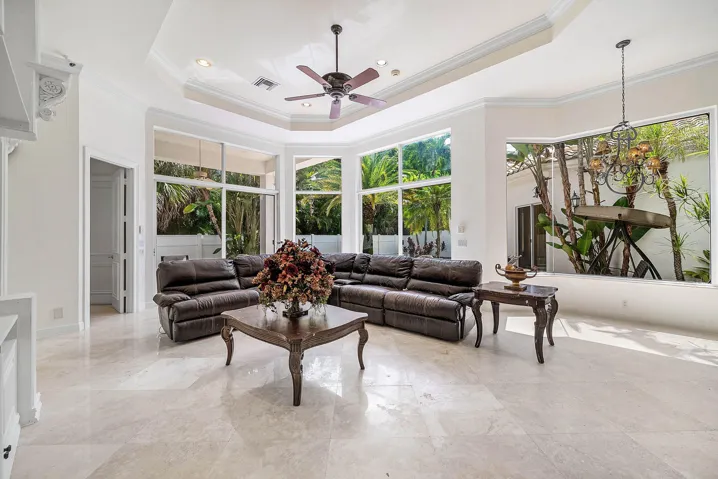 Expansive living space - walls of windows for natural light, marble flooring